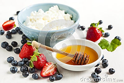 Fresh cottage cheese, honey and berries for healthy eating Stock Photo