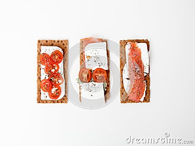 Fresh crispy breadcrumbs with trout fish, soft cheese and cherry tomatoes. Flat lay. Minimalism. Minimalism Stock Photo