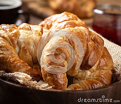 Fresh croissants in a wooden bowl Stock Photo