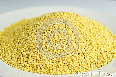 Fresh crumbly millet in a white plate Stock Photo