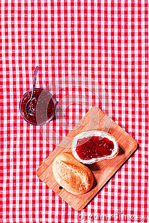 Fresh crusty roll with strawberry jam Stock Photo