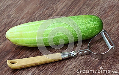 Fresh cucumber with peeler Stock Photo