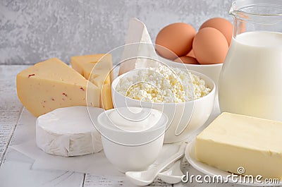 Fresh dairy products. Milk, cheese, brie, Camembert, butter, yogurt, cottage cheese and eggs on wooden table. Stock Photo