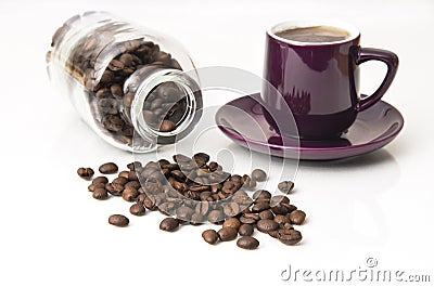 Fresh dark coffee beans with bottle and cup Stock Photo