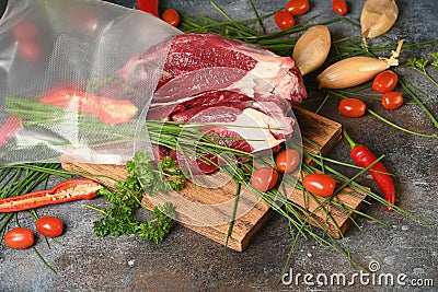 Fresh dark meat with ingredients for cooking on brown wooden cutting board. Stock Photo
