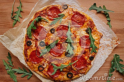 Fresh delisious pepperoni pizza on the wooden table, top view Stock Photo