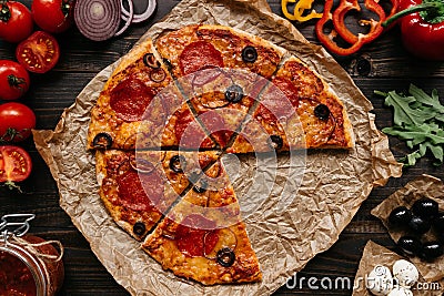 Fresh delisious pizza with pizza ingredients on the wooden table, top view Stock Photo