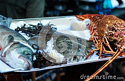 Fresh dorade, plaice and lobster on a platter Stock Photo