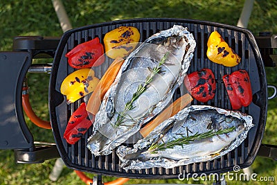 Fresh dorado fish and bell pepper grill cooking Stock Photo