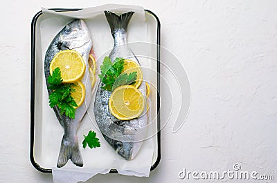 Fresh Dorado or Sea Bream with Lemon and Herbs, Raw Fish Ready to be Cooked, Top View Stock Photo