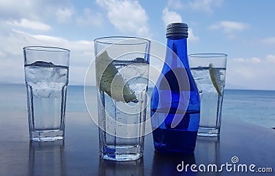 Fresh drinks against the bright blue sky and sea in Kos, Greece Stock Photo