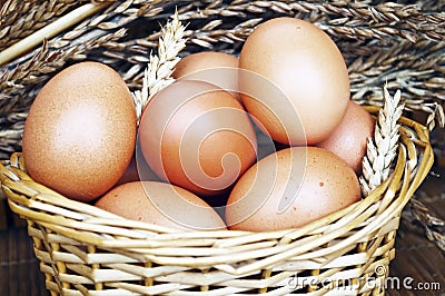 Fresh eggs in wickery basket Stock Photo