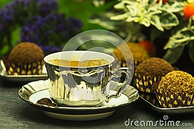 Fresh espresso coffee in luxury cup with a few chocolate candies Stock Photo