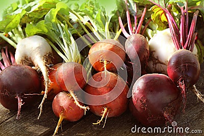 Fresh farm colorful beetroot on a wooden background. Detox and health. Selective focus. Red, golden, white beet Stock Photo