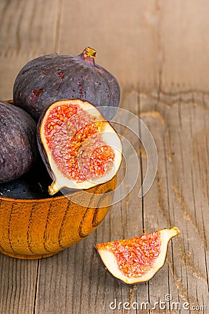 Fresh fig fruits on rustic wooden plate Stock Photo