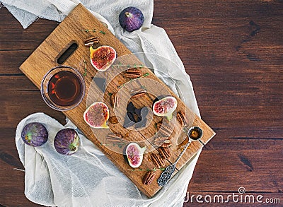 Fresh figs, chocjlate and pekan nuts with honey on a wooden boar Stock Photo