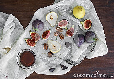 Fresh figs, chocolate, pears and pekan nuts with honey on a wood Stock Photo