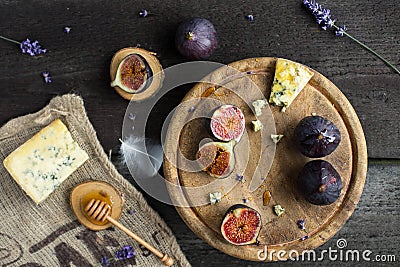 Fresh figs with honey and blue cheese on rustic wooden background Stock Photo