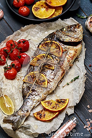 Fresh fish dorado. Raw dorado fish and ingredient for cooking. Fresh fish gilt-head bream dorade with salt, herbs and pepper. Stock Photo