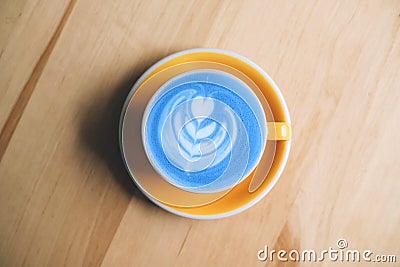 Fresh flavored blue matcha art on wooden background. Stock Photo