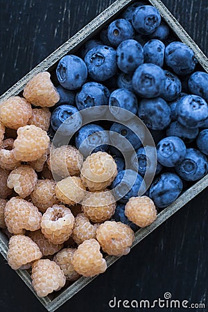 Fresh flavored blueberries and raspberries like a background in Stock Photo