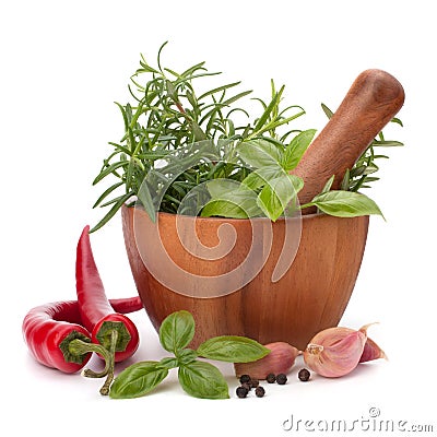 Fresh flavoring herbs and spices in wooden mortar Stock Photo