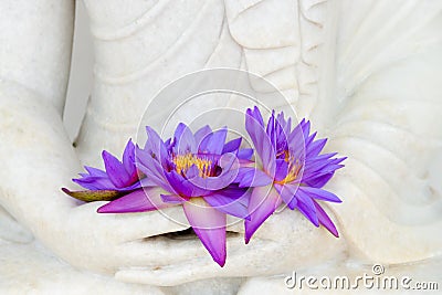 Fresh flowers in Buddha image hands Stock Photo