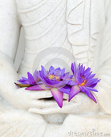 Fresh flowers in Buddha image hands Stock Photo