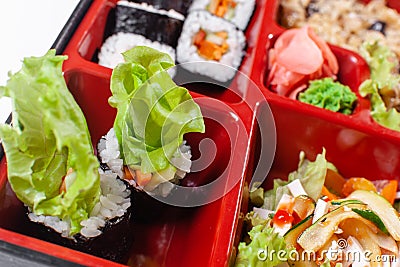 Fresh food portion in japanese bento box with salad, main course. Sushi roll with vegetables. Vegetarian dish. Stock Photo