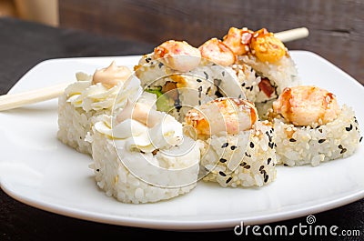 A set of cut Japanese sushi rolls on a white plate closeup Stock Photo