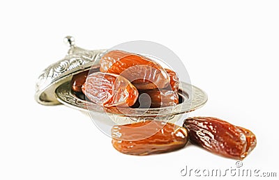 Fresh fruit dates in a silver metal bowl on isolated white background Stock Photo