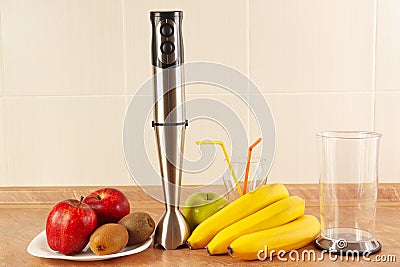 Fresh fruit, glasses and blender to prepare homemade smoothies Stock Photo