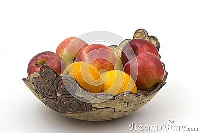 Fresh fruits in a clay bowl - oranges and apples Stock Photo