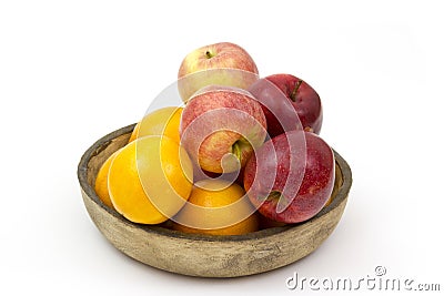 Fresh fruits in a clay bowl - oranges and apples Stock Photo