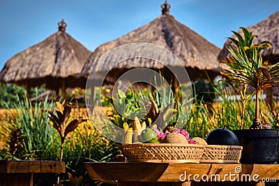 Fresh fruits on a plate in Interior of a traditional Balinese cafe in a rice field. Stock Photo