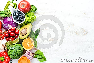 Fresh fruits and vegetables on a white wooden background. Top view. Stock Photo