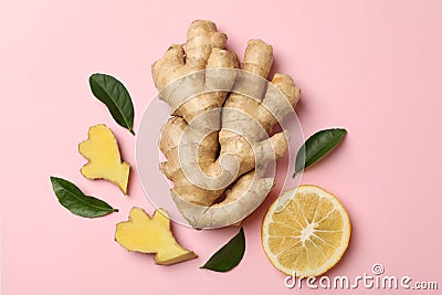 Fresh ginger, leaves and lemon on pink background Stock Photo