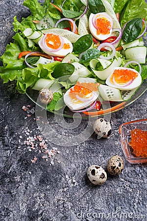 Fresh gourmet salad with red salmon caviar and eggs and vegetables. Protein luxury delicacy healthy food. beautifull served Stock Photo
