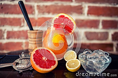 Fresh grapefruit lemonade with lime and lemons in a jug Stock Photo