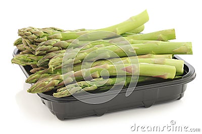 fresh green asparagus tips on a black plastic tray Stock Photo