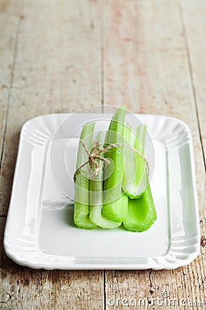 Fresh green celery stems in plate Stock Photo