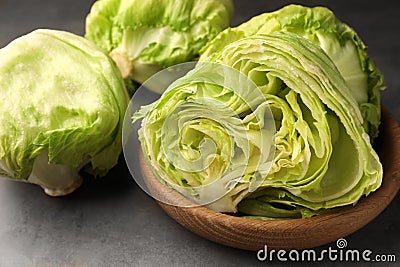 Fresh green cut and whole iceberg lettuce heads on grey table, closeup Stock Photo