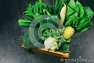 Fresh green fruit and green vegetables mixed in wooden box at market , top view various for healthy food vegan cook / Healthy food Stock Photo