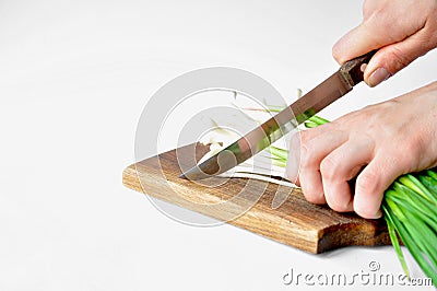 Fresh green garlic on the board with a knife Stock Photo