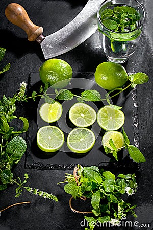 Fresh green lime and mint on black background, top view, square image. Stock Photo