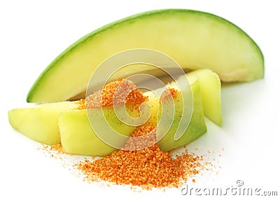 Fresh green mango with table salt mixed with ground chili Stock Photo