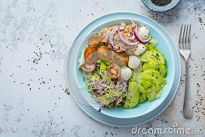 Fresh green mixed salad bowl with tuna, mozzarella and microgreens Stock Photo