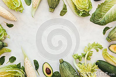Fresh green produce background with copy space, Green vegetables frame and wreath on white background. Avocados, corn, lettuce, Stock Photo