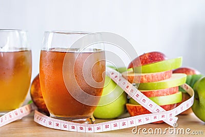 Fresh green and red apple slice and juice glasses with measuring tape Stock Photo