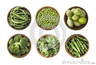 Fresh green vegetables isolated on a white background. Squash, green peas, broccoli, kale leaves and green bean in wooden bowl. Ve Stock Photo